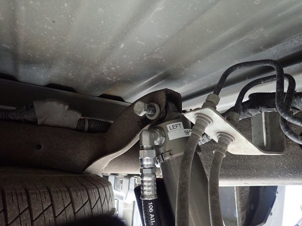 Remove upper and lower bolts from OEM shocks. Keep OEM bolts to install Elka shocks.