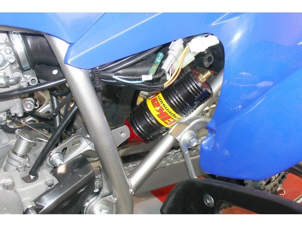 Make sure to route the hose according to the pictures.  Remove the plastic cover on the left side of the vehicule to pass the reservoir.  The compression adjustment knobs should be facing the bottom of the vehicule for convenient access.  Re-install the plastic cover.