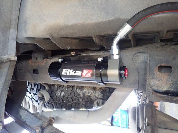 Place right reservoir into holding clamps as shown as far back as you can. Torque clamps bolts at 12 foot/pounds. (Right side shown)