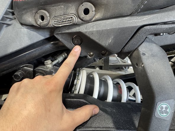 Remove the 2 last bolts holding the rear section of the Ryker as shown.