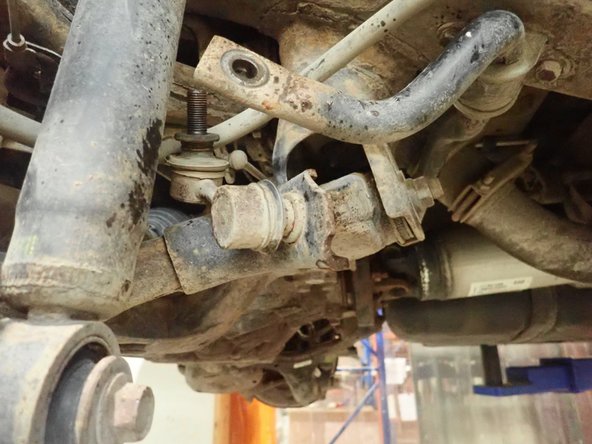 Remove sway-bar link on one side to allow lowers arms to temporary move separately.