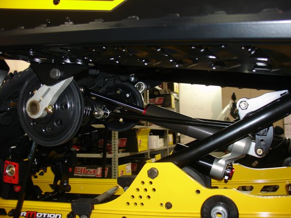 Install the Elka rear shock with the reservoir at the bottom and oriented towards the rear of the snowmobile as shown on the photo.