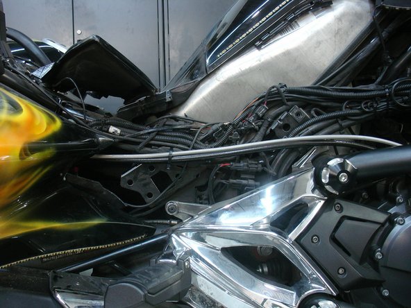 Install reservoir bracket with threaded holes behind the frame, with the notch on top (see red circle). Be careful not install bracket over any cables.