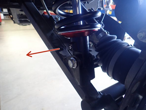 On Stage 2, Stage 4, and Stage 5 models the rebound adjuster located on lower eyelet of the shocks should be oriented towards the front of the vehicle, as shown. (Left side shown ). If needed, you can turn the lower eyelet to orient properly.
