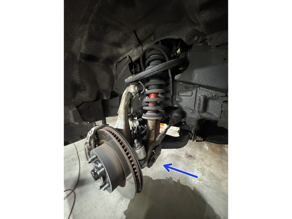 Remove the bolt and nut from the lower shock mounts.