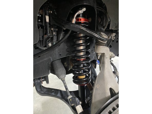 Reassemble the knuckle with the upper control arm. Torque the upper control arm nut to 70 Ft-Lb.