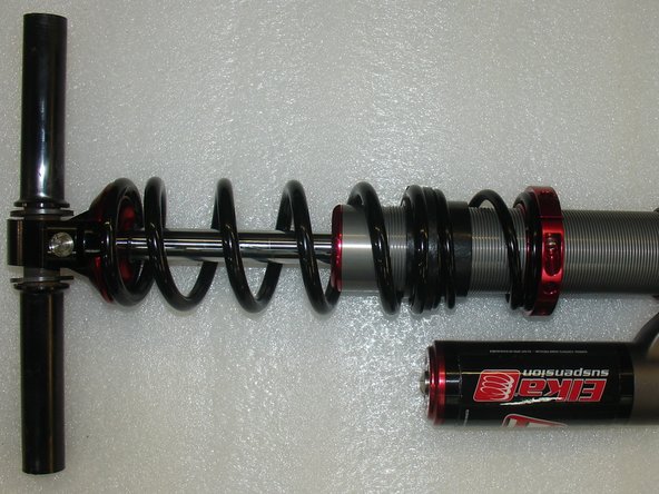 Install the sleeve through the bottom eye with the plastic spacer on both side of the eyelet.