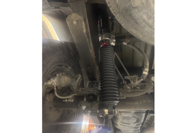 Install rear shocks with the reservoir facing the rear of the truck on the left side.