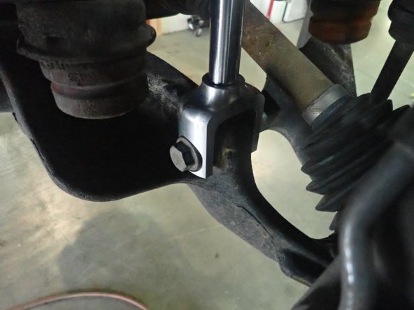 Begin to install OEM lower bolt into new Elka shock fork . Do not tighten for now.