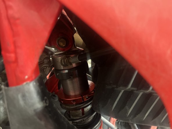 Install rear stage 5 shock with the hose fitting facing left of atv, and the hose going backward the atv.