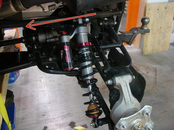 Install the  new Elka rear shocks with the piggyback reservoir at the top and oriented towards the front of the vehicle''' as indicated by the red Arrow on the photo