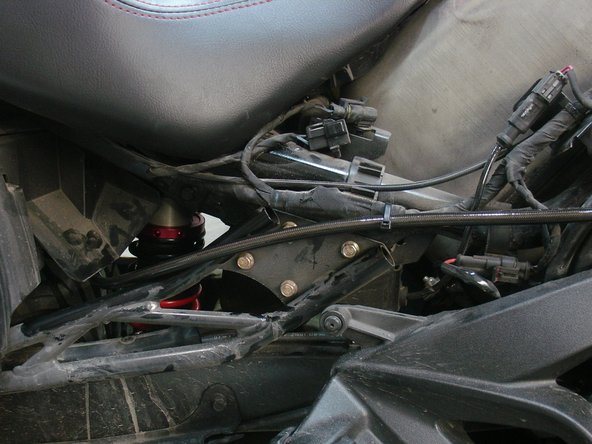Fix the shock in place with the OEM bolts.