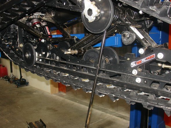 Remove the idler wheel on both side of the head rear shock