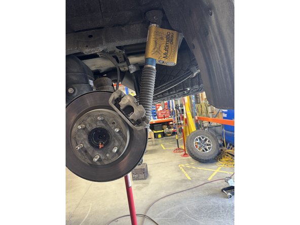 Remove upper and lower bolts from OEM shocks. Keep OEM bolts to install Elka shocks.