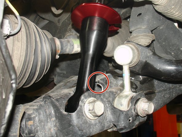 Install new Elka shocks begining by putting the lower eyelet in place. Then, pull the lower suspension arm down, and put upper part of shock in place.