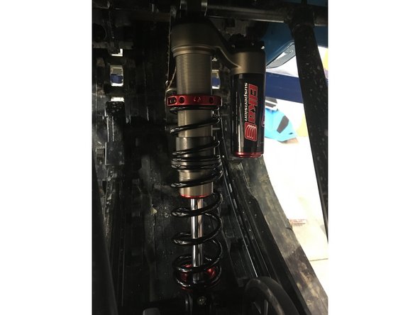 Install the Elka center shock with piggyback reservoir at the top and pointing towards the right side of the snowmobile as show on the photo.