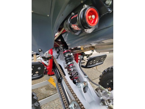 Install shock with the hose fitting on the left side of atv, and pointing rear of atv.