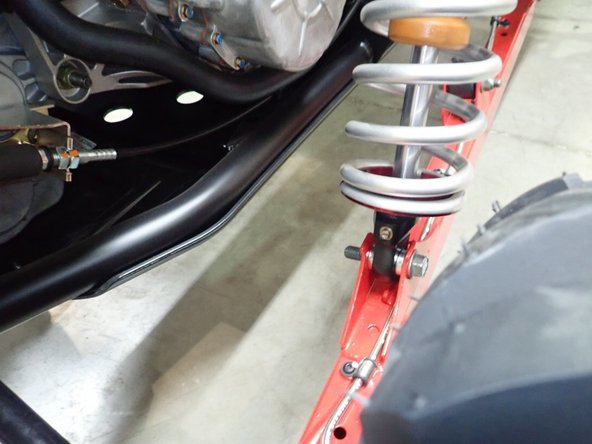 On Stage 2, Stage 4, and Stage 5 models the rebound adjuster located on lower eyelet of the shocks should be oriented towards the rear of the vehicle, as shown. (Right side shown ). If needed, you can turn the lower eyelet to orient properly.