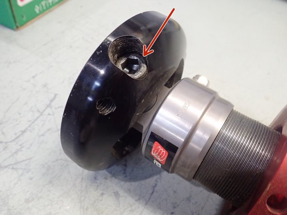 Shock absorber with top plates: to have access to spacer/bearing remove socket head screw in top plate then remove top plate.