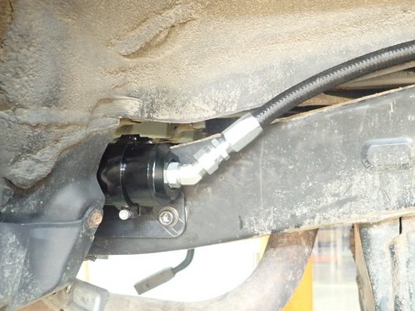 Slide reservoir into bracket clamps.