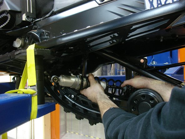 Remove the two spring supports to remove any tension on the torsion springs.