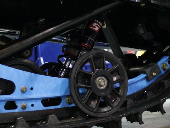 The lower shock eyelet rebound adjuster screw must be oriented toward the rear of vehicle,