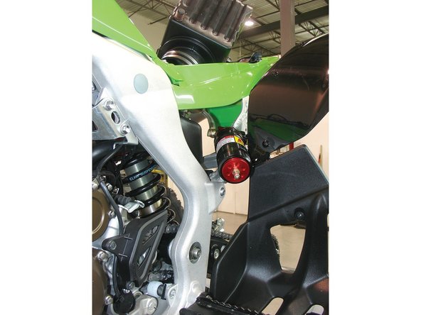 Route the reservoir’s hose above the small airbox chamber, pulling out the reservoir through the left side of the rear subframe. Attach the shock to the upper mount using the stock bolts.