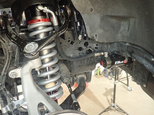 Reassemble the knuckle with the upper control arm. Torque the upper control arm nut to 70 Ft-Lb.