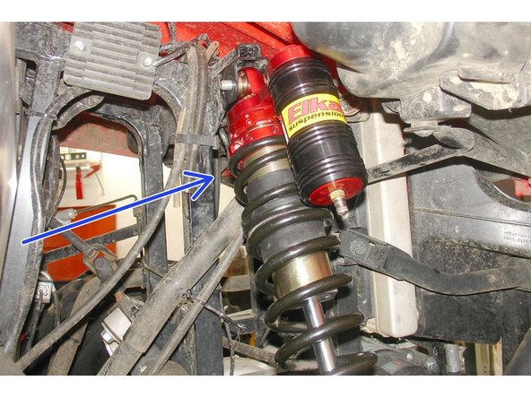 Tighten the top and bottom shock bolts to the proper manufacturer’s torque specifications.