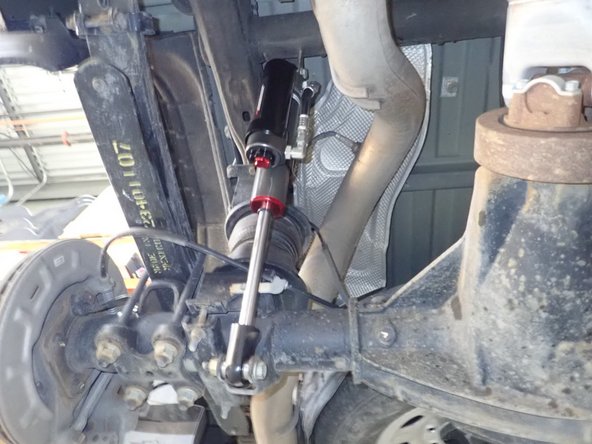 Remove upper and lower bolts from OEM shocks. Keep OEM bolts to install Elka shocks.