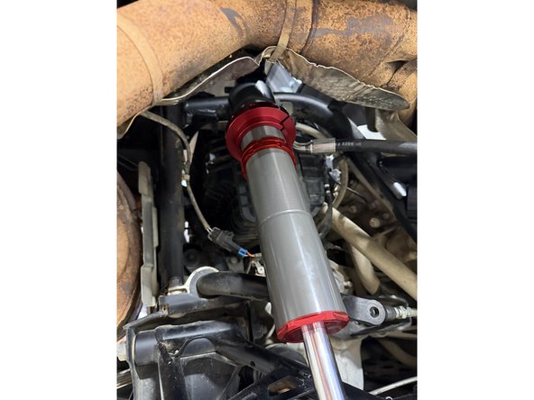 Note: The hose configurations differ between the left and right sides. Refer to the images to ensure the shocks are installed on the correct side.