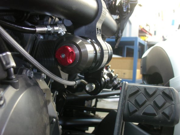 Route the hydraulic preload hose along with the shock hose. You can secure it with tie wrap.