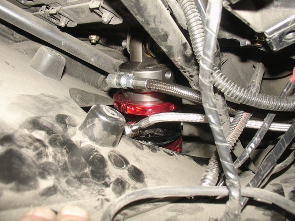 On Stage 4 and Stage 5, the shock must be installed with the hose fitting facing the rear of vehicle, so the hose going to right side