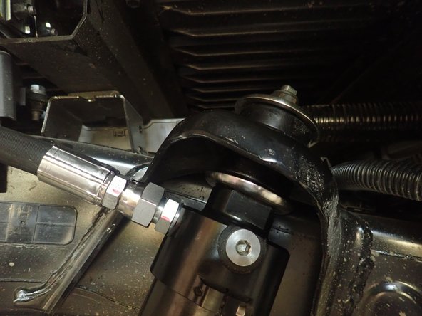 Apply some supplied grease on the 2 rubber isolators. There must be 1 isolator under and 1 over the shock mounting.