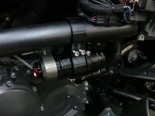 Install the second part of bracket, place the reservoir carefully as shown, and torque the 2 bolts at 10 ft/pnds