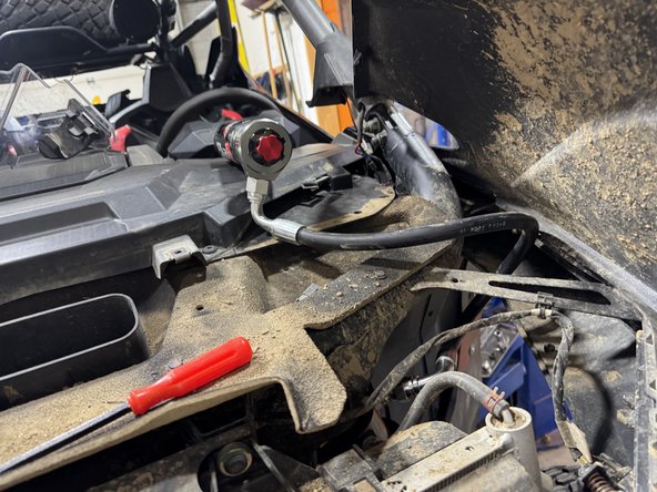 Pass the reservoir thru the fender as shown.