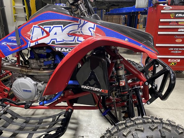 Install front shock with the piggyback reservoir up as shown.