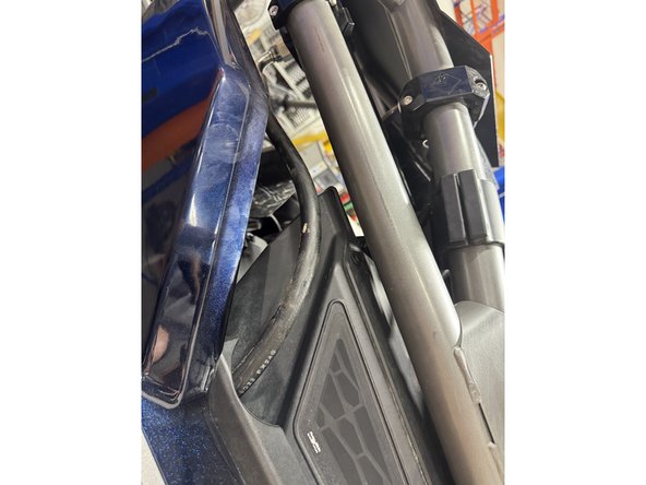 Pass the reservoir thru the fender as show.