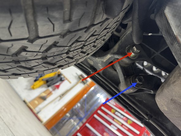 Remove the upper shock bolt.