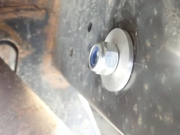 Use second spacer and provided nut to fix bracket in place.