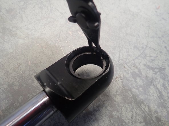 Install a new circlip in one of the shock's end grooves. Make sure the clip is properly seated in its groove.
