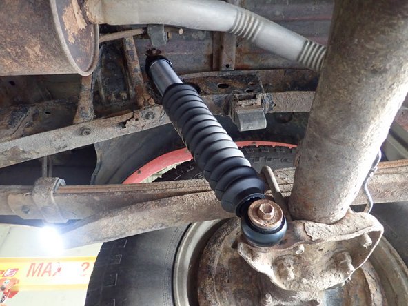 Do not use the OEM washers with bigger I.D. that goes over the studs. Push shock firmly in place, than use OEM bolts and washers to secure shocks in place as shown by green circle.