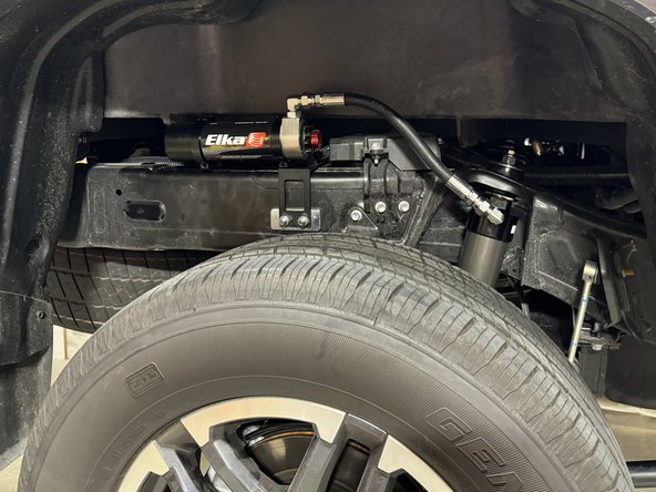 Install the reservoir in the the bracket. When the reservoir is placed properly,  torque bracket's bolts at 10 Ft-Lb.