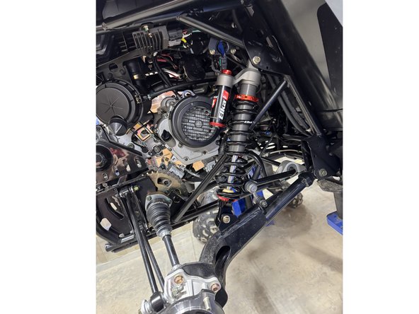 On Stage 2, Stage 4 and Stage 5 models, the lower shock eyelets should be installed with the rebound adjuster oriented towards the rear of the vehicle ( right side shown ). If needed, you can turn the lower eyelet to orient properly.