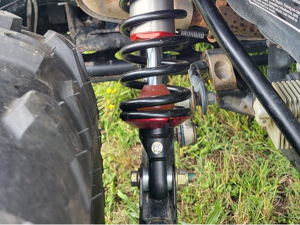 On Stage 2, Stage 4, and Stage 5 models the rebound adjuster located on lower eyelet of the shocks should be oriented to the rear of the vehicle, as shown. (Left side shown ). If needed, you can turn the lower eyelet to orient properly.