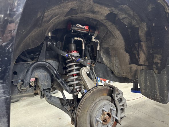 Reassemble the knuckle with the upper control arm. Torque the upper control arm nut to factory spec