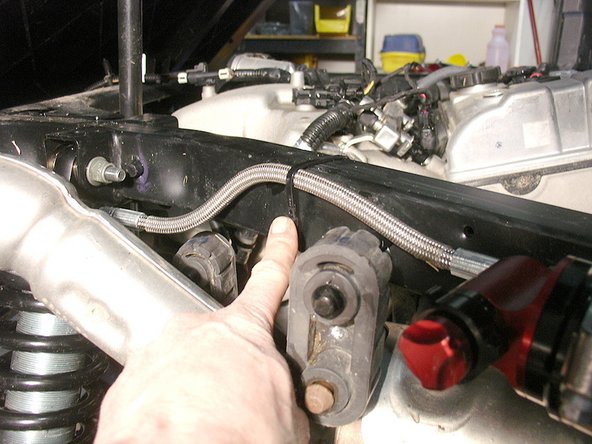 Secure the hose to the frame using a zip-tie as shown.