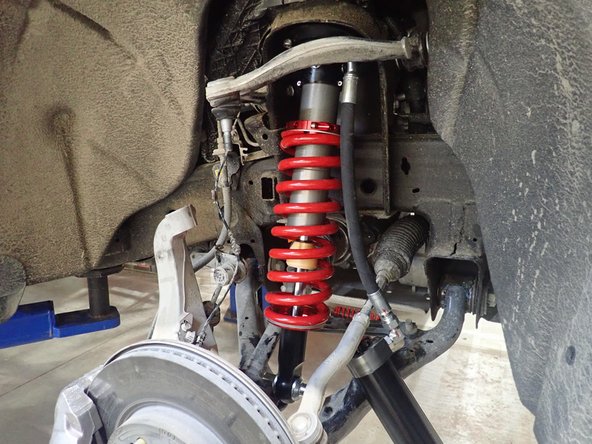 Be sure the lower mount's flats are facing lower arm as shown by blue circle. You can turn the lower pin if needed.