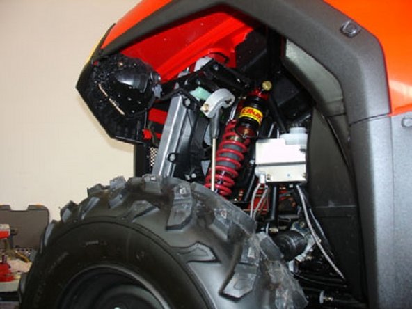 Tighten the top and bottom shock bolts to the proper manufacturer’s torque specifications.