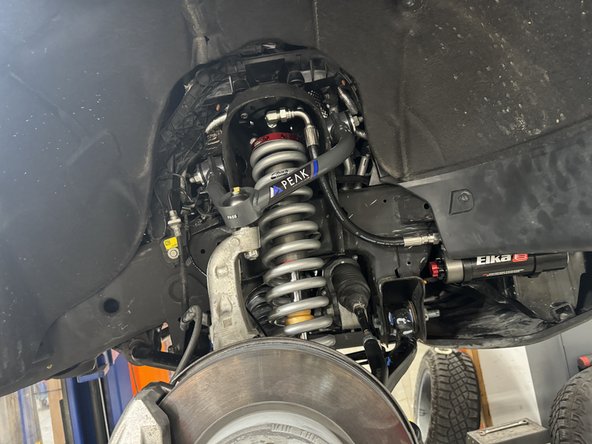 Start installation with the provided lower bolts and washers. Apply threads locker on bolts, then torque them at 50 ft.lb.